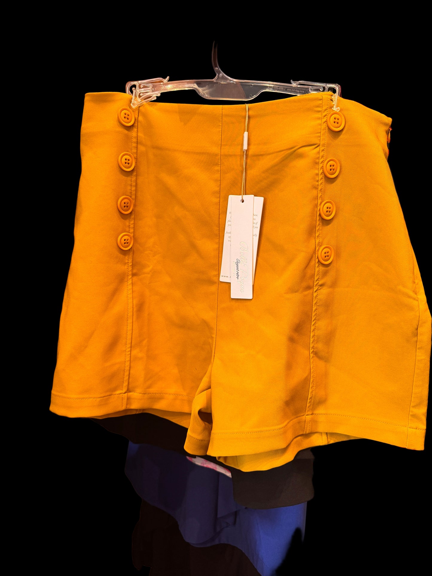 Yellow jacket with buttons on a clothing rack