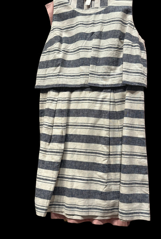 Striped dress with a layered design hanging against a neutral background