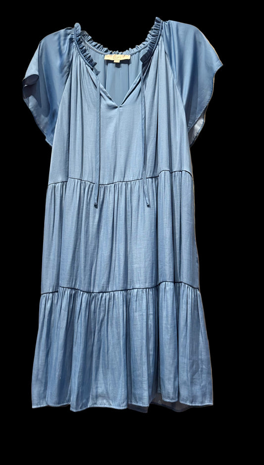 Blue dress on a rack with a red dress in the background